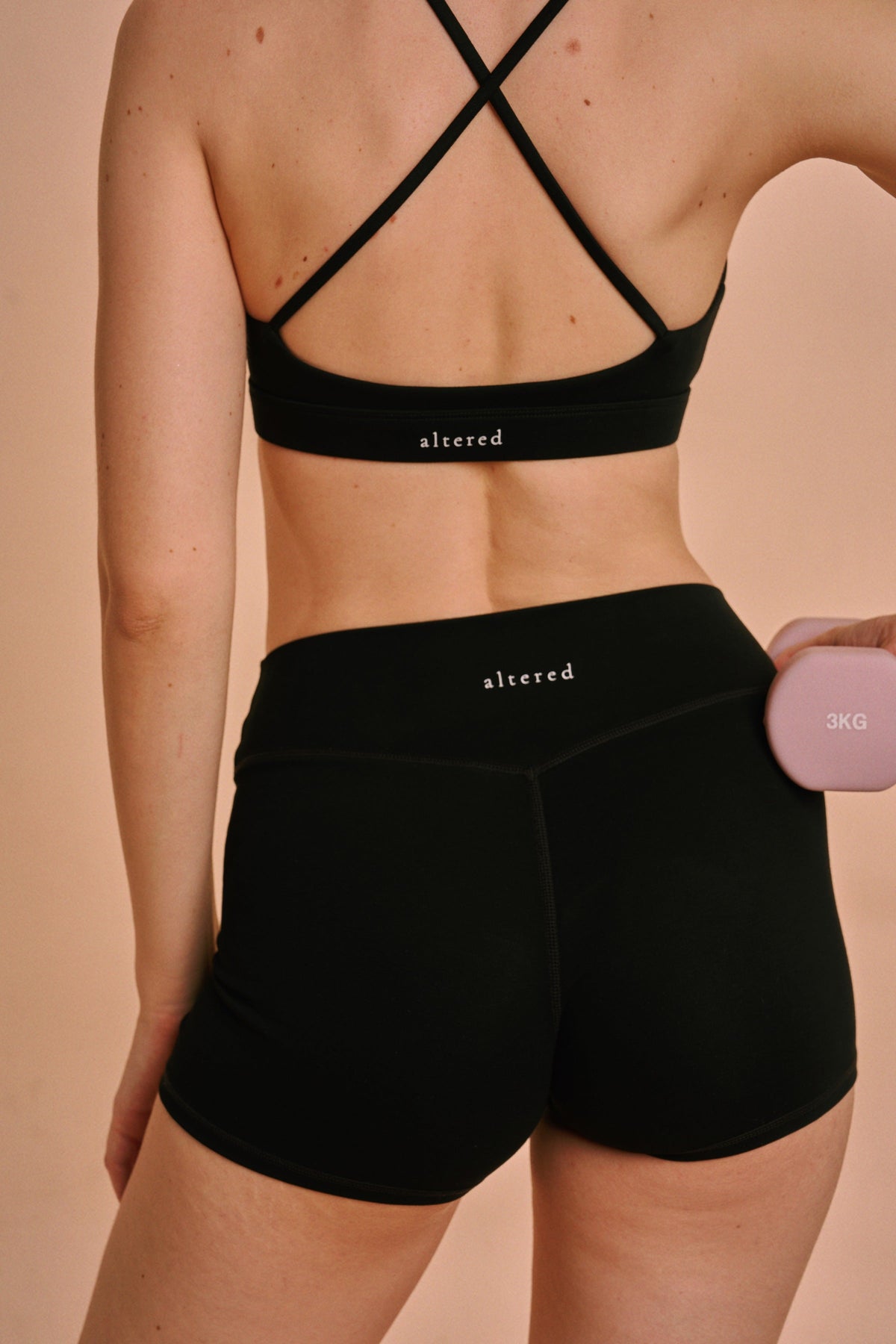Altered Active bike short and crop bra, back detail with wordmark